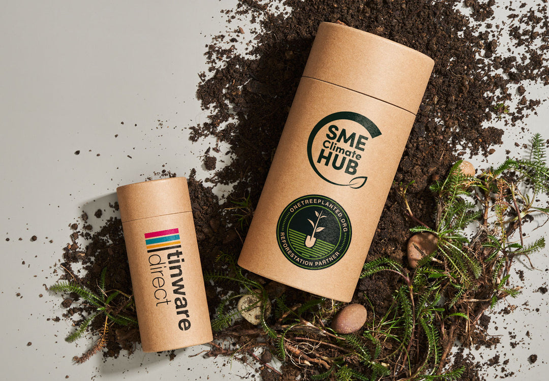 Zwei Pappröhren mit Tinware Direct-Logo. Eine Röhre hat das One Tree Planet Reforestation Partner-Logo und das SME Climate Hub-Logo.